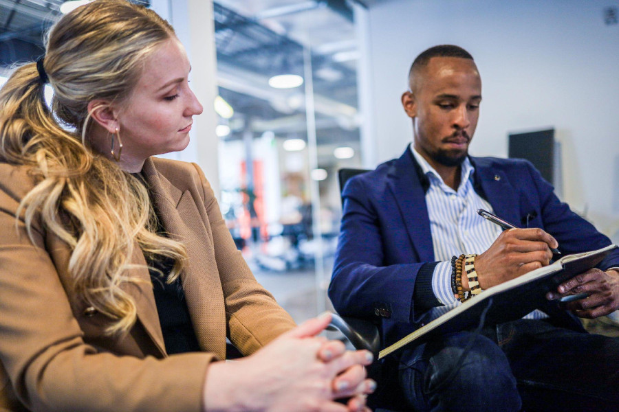 two people sitting at an office checking their SEO statistics